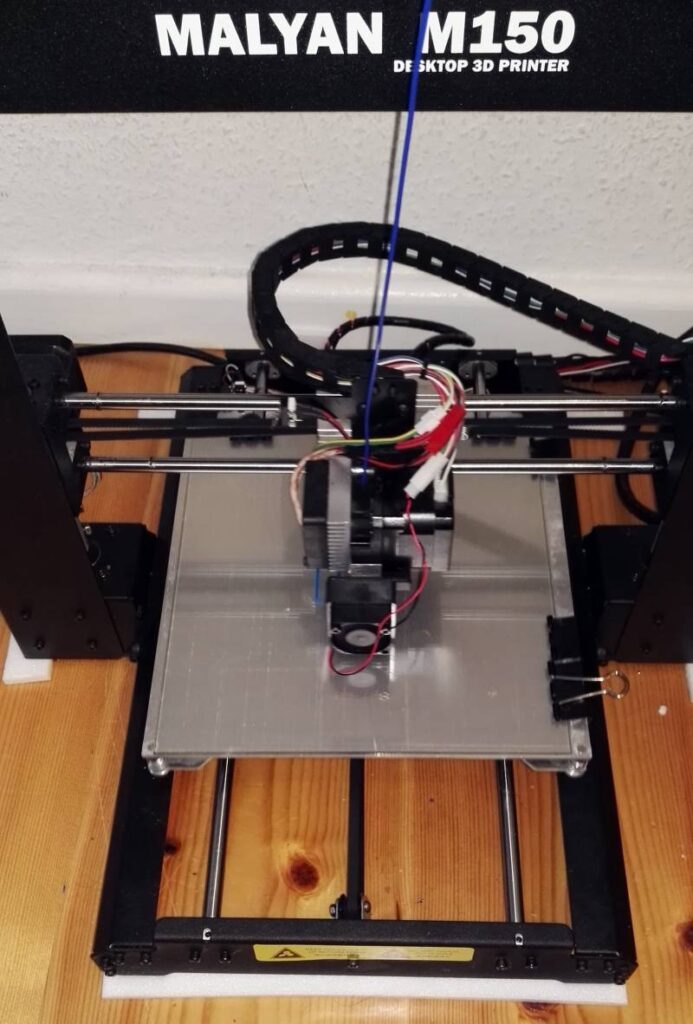 3D printer printing PLA on glass
